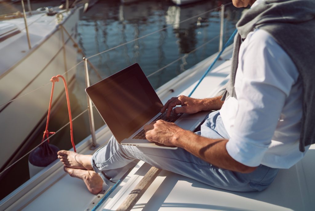 Man on boat researching how to qualify for life insurance