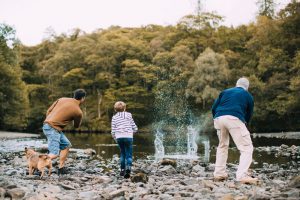Long Term Life Insurance blog image of grandfather, son and grandson skipping rocks